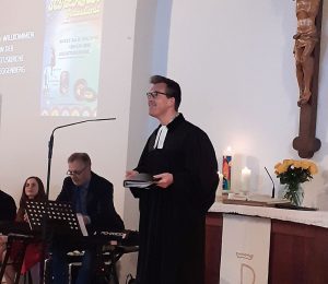 Am Foto ist der Pfarrer der evangelischen Gemeinde Herr Friedrich Eckhardt und die Livemusiker zu sehen.